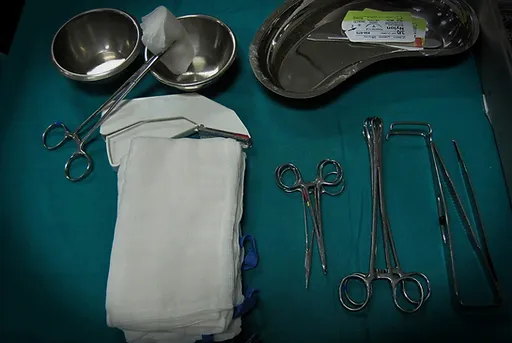 An image of surgical equipments like scissors, cotton etc