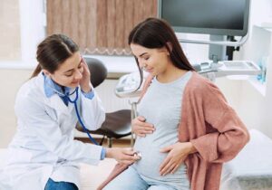 An image of a gynaecologist checking and observing a mothers womb